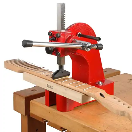 An arbor press, like those used by Fender/CBS