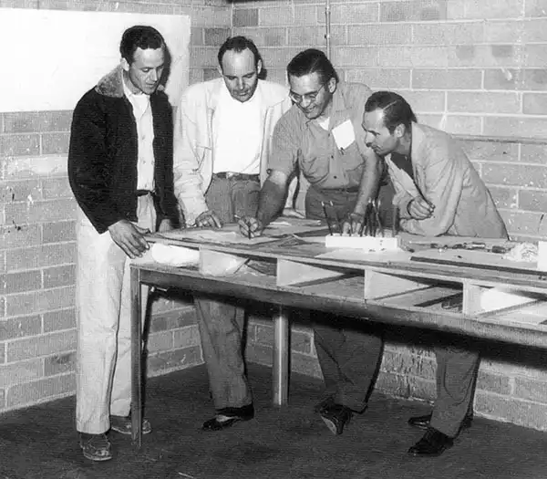 Freddie Tavares and George Fullerton on a drafting table