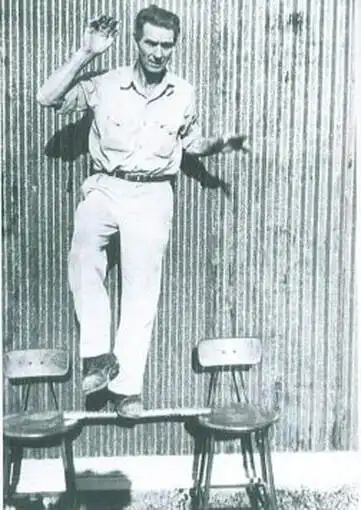 Fender employee Hugh Garrlott stands on an Esquire neck without the truss rod to prove that Fender neck would never wrap