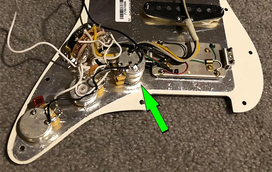 An American Standard Stratocaster HSS Shawbucker loaded pickguard. Note the Dual Pot.