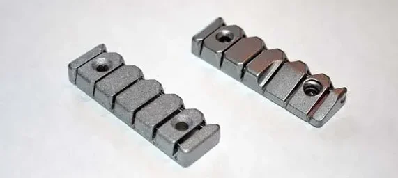 The Wilkinson Roller Nut. On the right, the earlier "split" version, on the left, the "full" nut