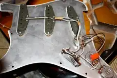3-ply, 11-hole white pickguard with full-size metal shielding on a '62 Strat