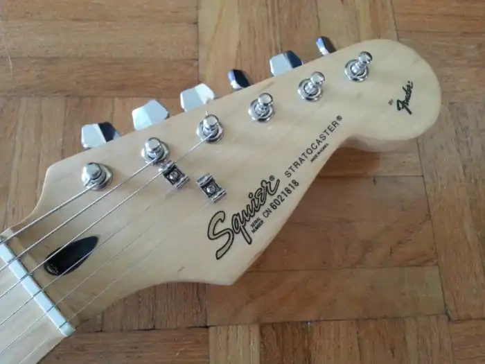 Headstock redesigned with a gold Squier logo