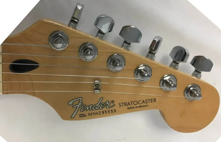 Headstock with whitish Modern logo and decals of the first Mexican Series Standard Stratocaster. Note the black plastic truss-rod access