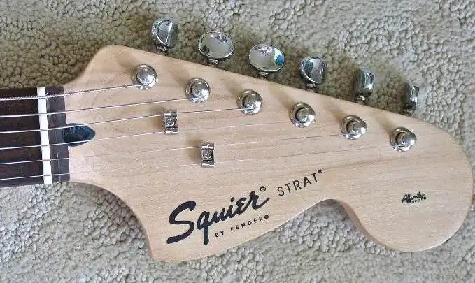 Indonesian-made Squier Affinity Stratocaster included in the Pak, featuring a black insert for truss rod access