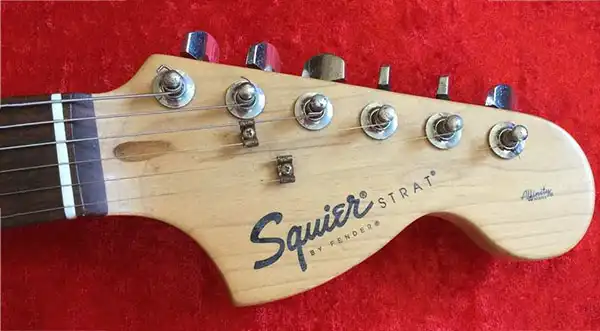 Chinese-made Squier Affinity Stratocaster with a large headstock, lacking a black insert