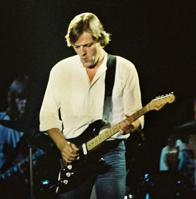 David Gilmour of Pink Floyd performs at Earls Court Exhibition Centre during The Wall tour on 7 August 1980 in London. His Black Strat featured a 21-fret Charvel neck